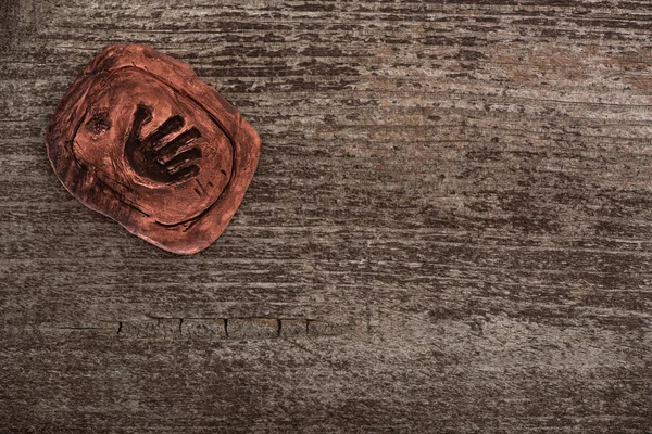 Top view of shamanic clay talisman on wooden surface — Stock Photo