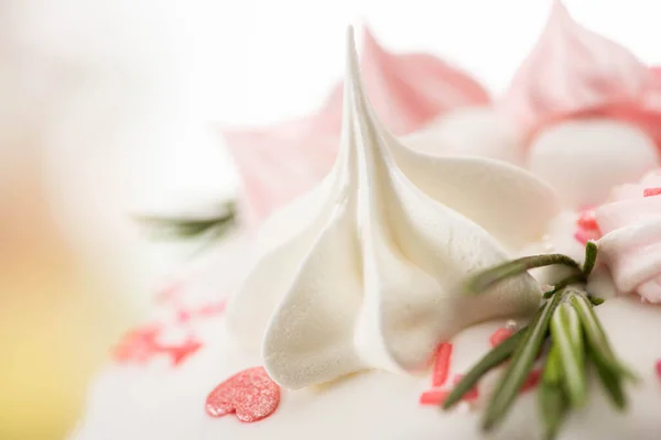 Close up view of delicious easter cake with pink and white meringue and rosemary — Stock Photo