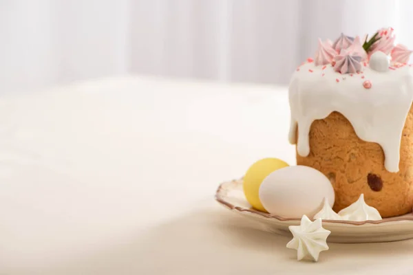 Delicious Easter cake decorated with meringue with colorful eggs on plate — Stock Photo