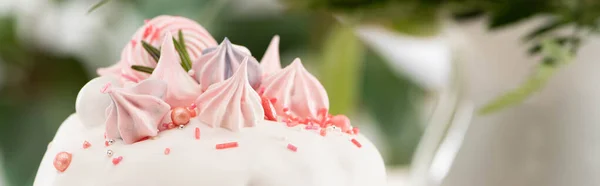 Close up view of delicious Easter cake with white glaze and meringue, panoramic shot — Stock Photo