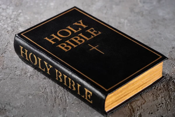 Biblia santa sobre superficie texturizada gris - foto de stock