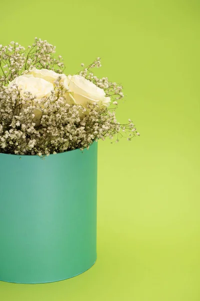 Fresh bouquet of flowers in gift box isolated on green — Stock Photo