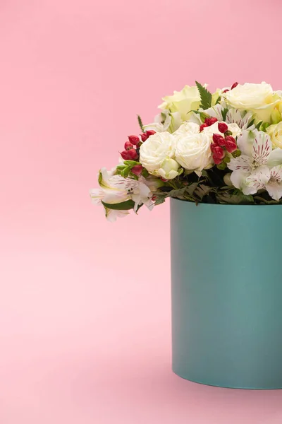 Bouquet of flowers in turquoise gift box on pink background — Stock Photo