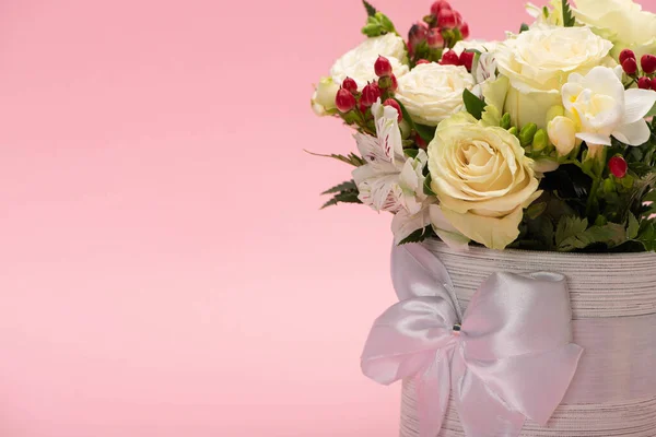 Букет квітів у святковій подарунковій коробці з бантом ізольований на рожевому — стокове фото