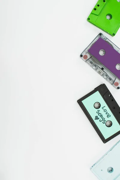 Top view of green, purple and turquoise cassettes on white background — Stock Photo