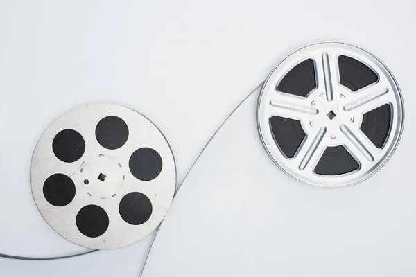 Top view of film reels and film strip on white background — Stock Photo