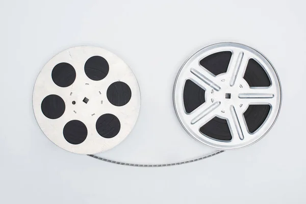 Top view of movie reels with film strip on white background — Stock Photo