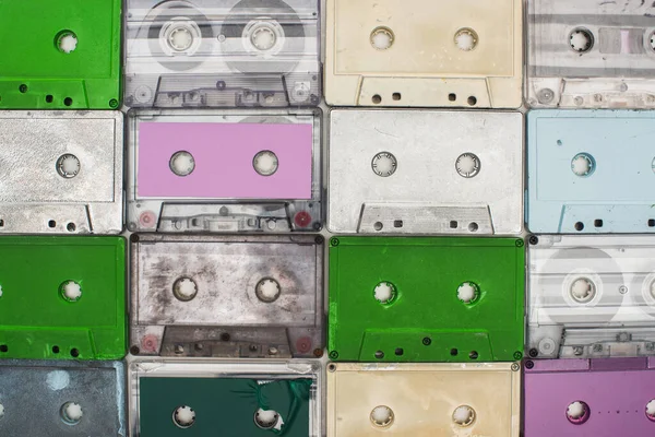 Collage of purple, green, turquoise and white old recording cassettes — Stock Photo