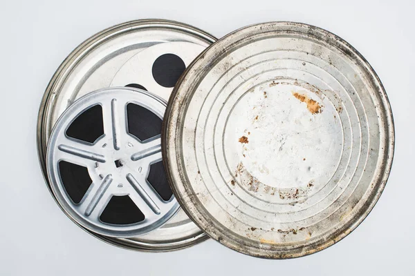 Top view of film reels with tape in rusty tin case on white background — Stock Photo