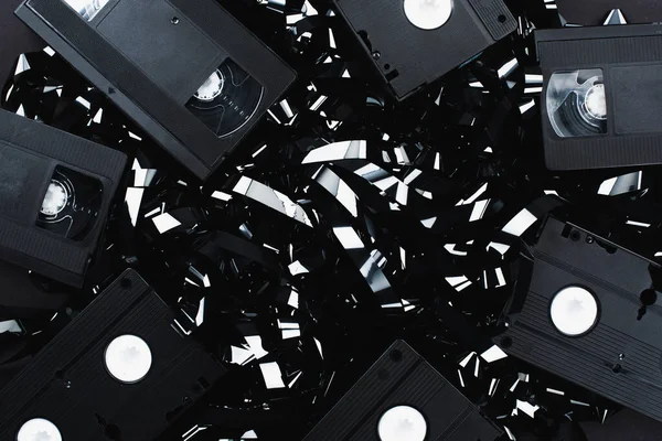 Top view of VHS cassettes on black film strip — Stock Photo