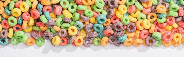 Top view of bright multicolored breakfast cereal on white background, panoramic shot — Stock Photo