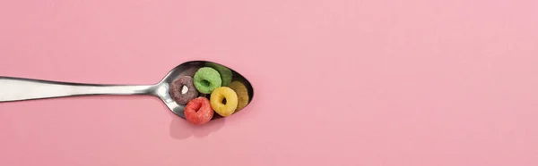 Top view of bright colorful breakfast cereal in spoon on pink background, panoramic shot — Stock Photo