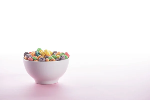 Bright multicolored breakfast cereal in bowl on white background — Stock Photo