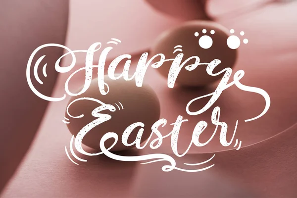 Selective focus of chicken eggs in shadow in spiral paper pink swirls with happy Easter illustration — Stock Photo