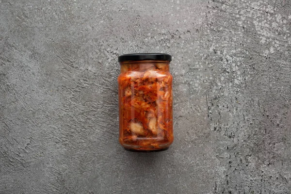Top view of kimchi in jar on grey concrete background — Stock Photo