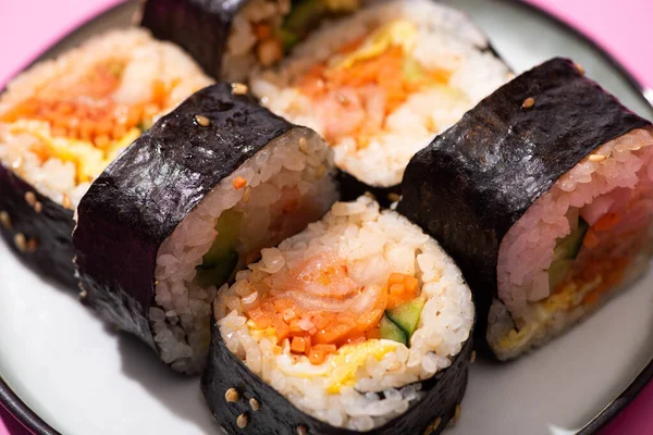 Close up of tasty korean gimbap with vegetables and salmon — Stock Photo