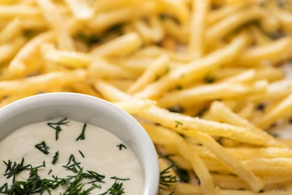 Close up of garlic sauce near crispy french fries with dill — Stock Photo