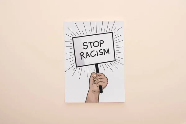 Top view of picture with drawn hand and stop racism placard on beige background — Stock Photo
