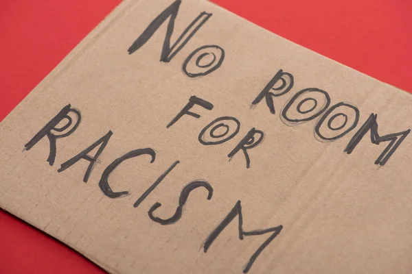 Carton placard with say no room for racism lettering on red background — Stock Photo