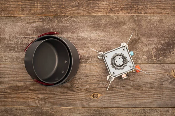 Top view of gas burner and metal dishes on wooden surface — Stock Photo