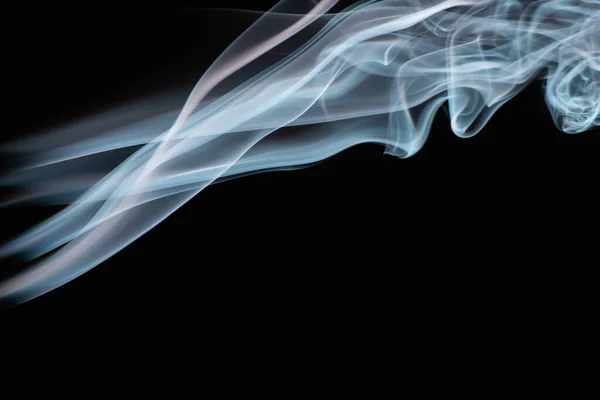 Blue colorful flowing smoke on black background — Stock Photo