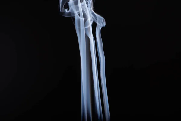 Abstract white flowing smoke clouds on black background — Stock Photo