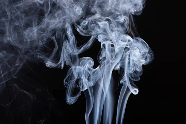 Abstract white flowing smoke clouds on black background — Stock Photo