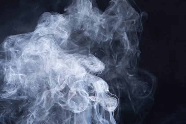 Abstract white flowing smoke on black background — Stock Photo