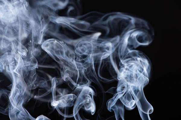 Abstract white flowing smoke on black background — Stock Photo