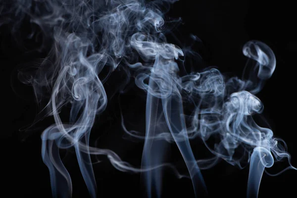 Abstract white flowing smoke on black background — Stock Photo