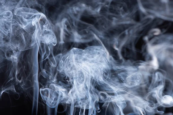 White flowing smoke clouds on black background — Stock Photo