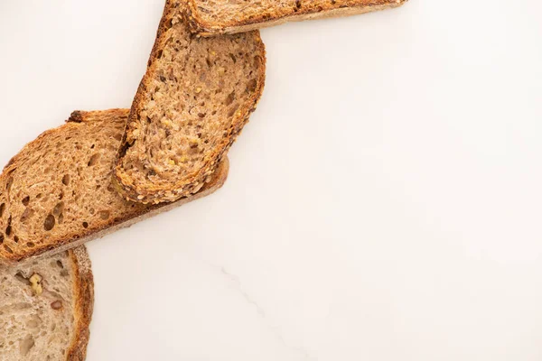 Ansicht von Vollkornbrotscheiben auf weißem Hintergrund mit Kopierfläche — Stockfoto