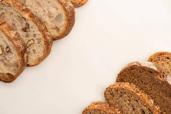 Top view of whole wheat bread slices on white background with copy space — Stock Photo