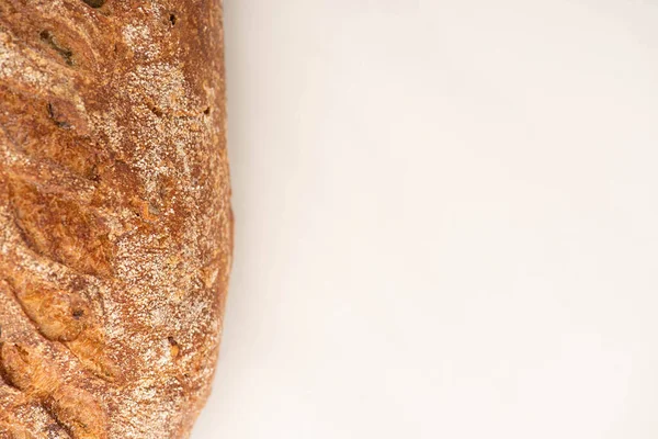 Top view of fresh whole wheat bread loaf on white background with copy space — Stock Photo