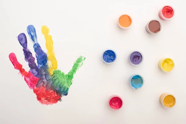 Draufsicht auf bunte Handabdrücke und Farben auf Weiß zum Welt-Autismus-Tag — Stockfoto