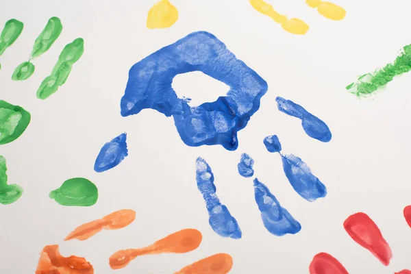 Top view of colorful hand prints on white for World Autism Awareness Day — Stock Photo