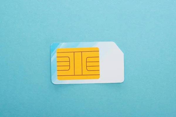 Top view of sim card on blue background — Stock Photo