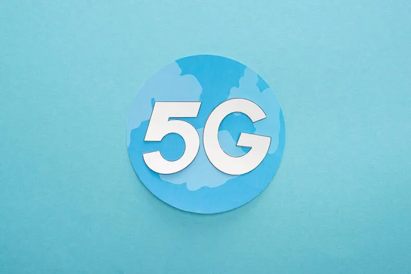 Top view of white 5g lettering on globe on blue background — Stock Photo