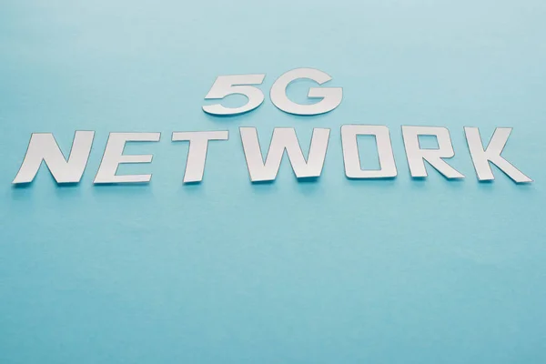 White 5g network lettering on blue background — Stock Photo