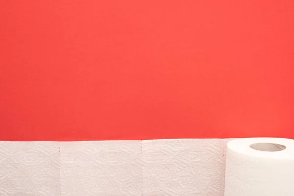 Top view of white toilet paper roll on red background with copy space — Stock Photo