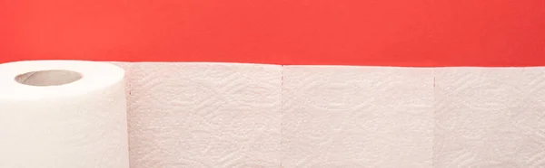 Top view of white toilet paper roll on red background, panoramic shot — Stock Photo