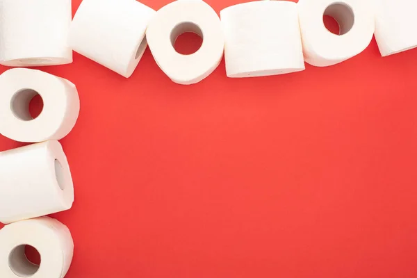 Top view of white toilet paper rolls on red background with copy space — Stock Photo