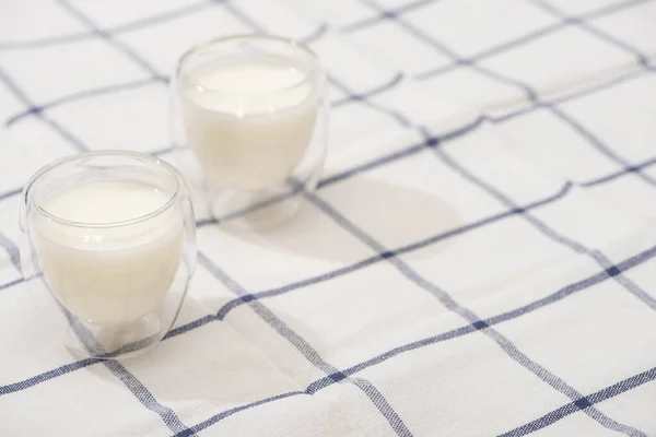 High angle view of glasses of homemade yogurt on plaid fabric — Stock Photo