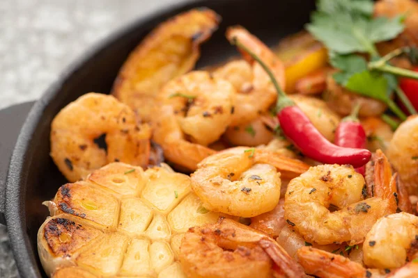 Close up view of fried shrimps with grilled corn, chili peppers — Stock Photo