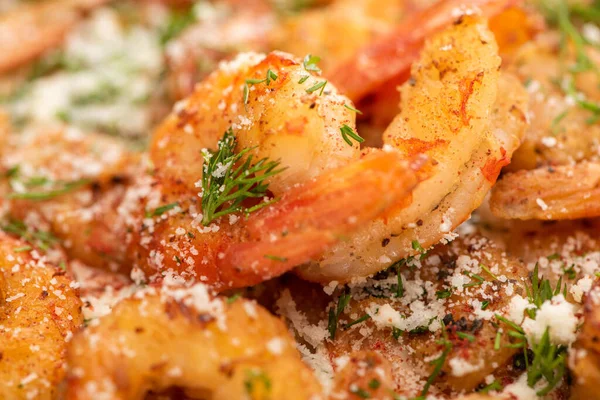 Close up view of fried shrimps with dill and grated cheese — Stock Photo