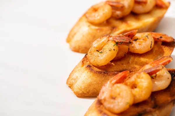 Close up view of canape with toast bread and fried shrimps on white background — Stock Photo