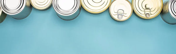 Top view of cans on blue background with copy space, food donation concept — Stock Photo