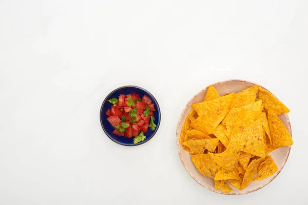 Top view of corn nachos with chili on white background — Stock Photo