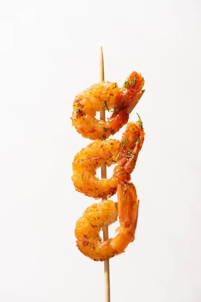 Close up view of tasty fried prawns on skewer on white background — Stock Photo