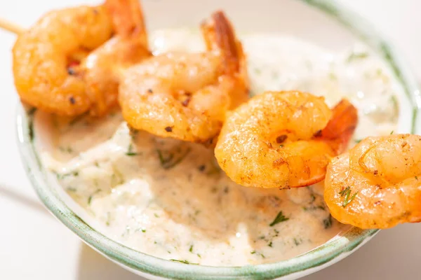 Close up view of delicious fried prawns on skewer with sauce — Stock Photo